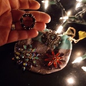 Four vintage brooches and pouch